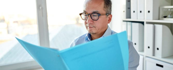 business man looking at bookkeeping record